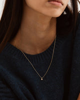 A woman wearing the Varni Necklace | Champagne Argyle Diamond. 