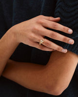 A woman's hand showcasing the Calla Ring | Diamond | Yellow Gold.