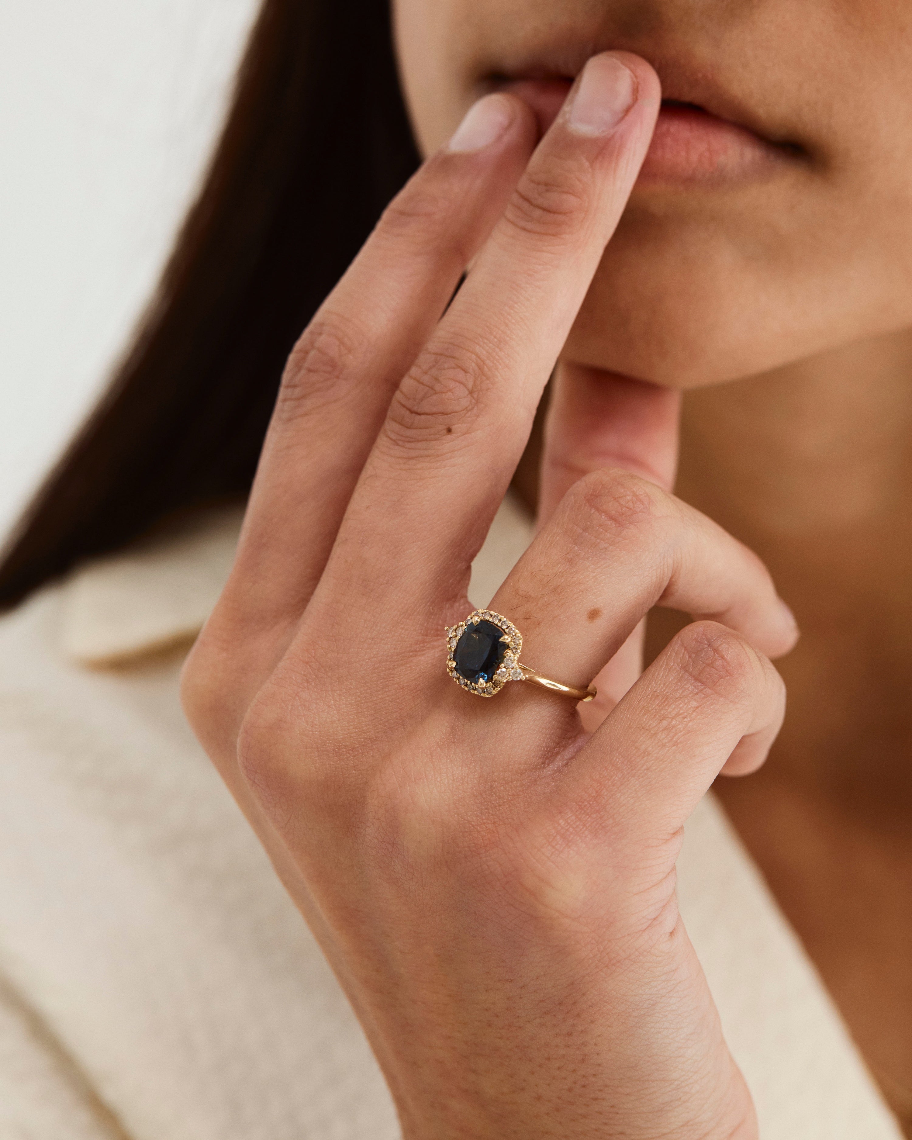 A model's hand showcasing the Winona | Cluster Ring | Sapphire | Yellow Gold.