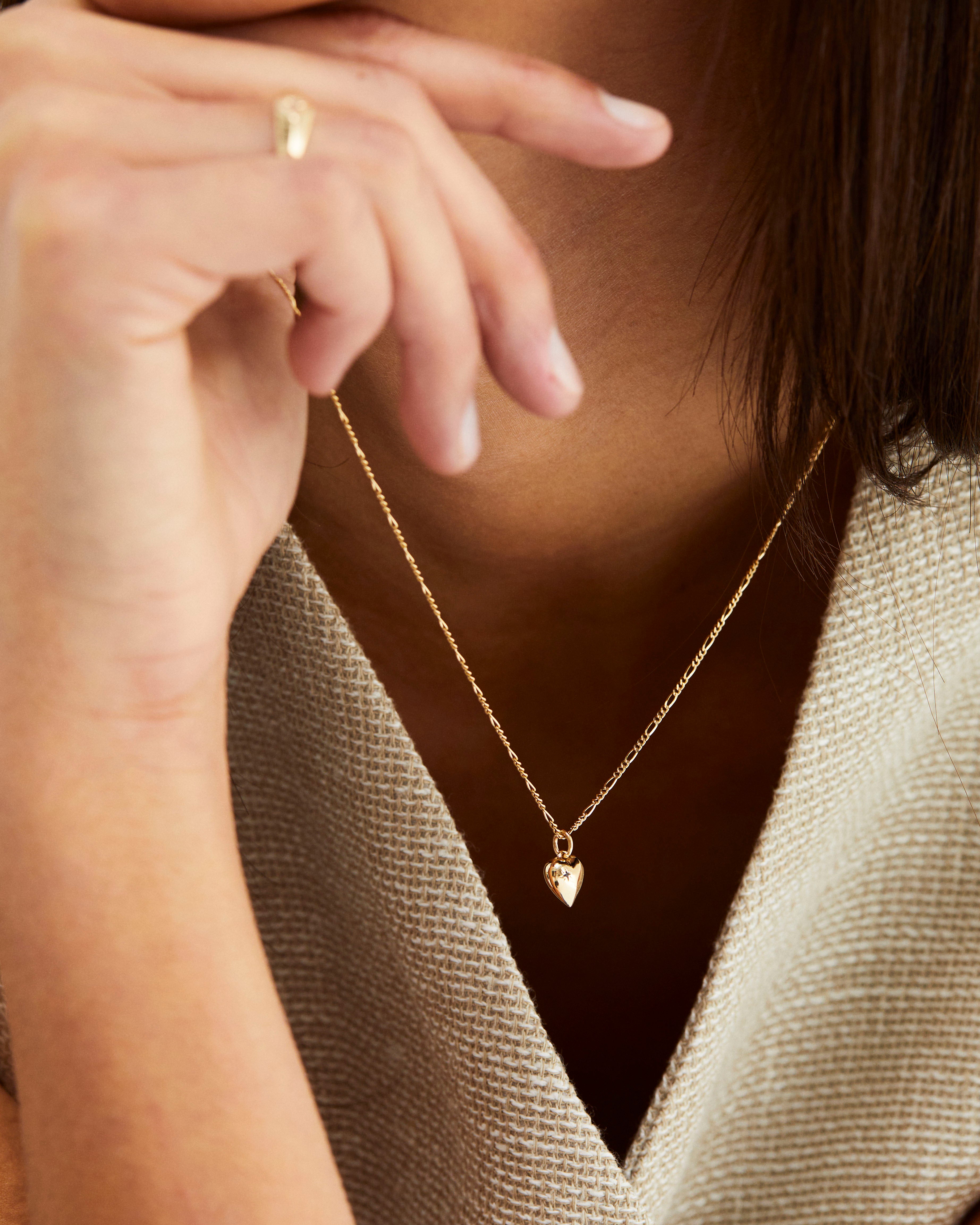 A woman wearing the Ella Necklace in Yellow Gold