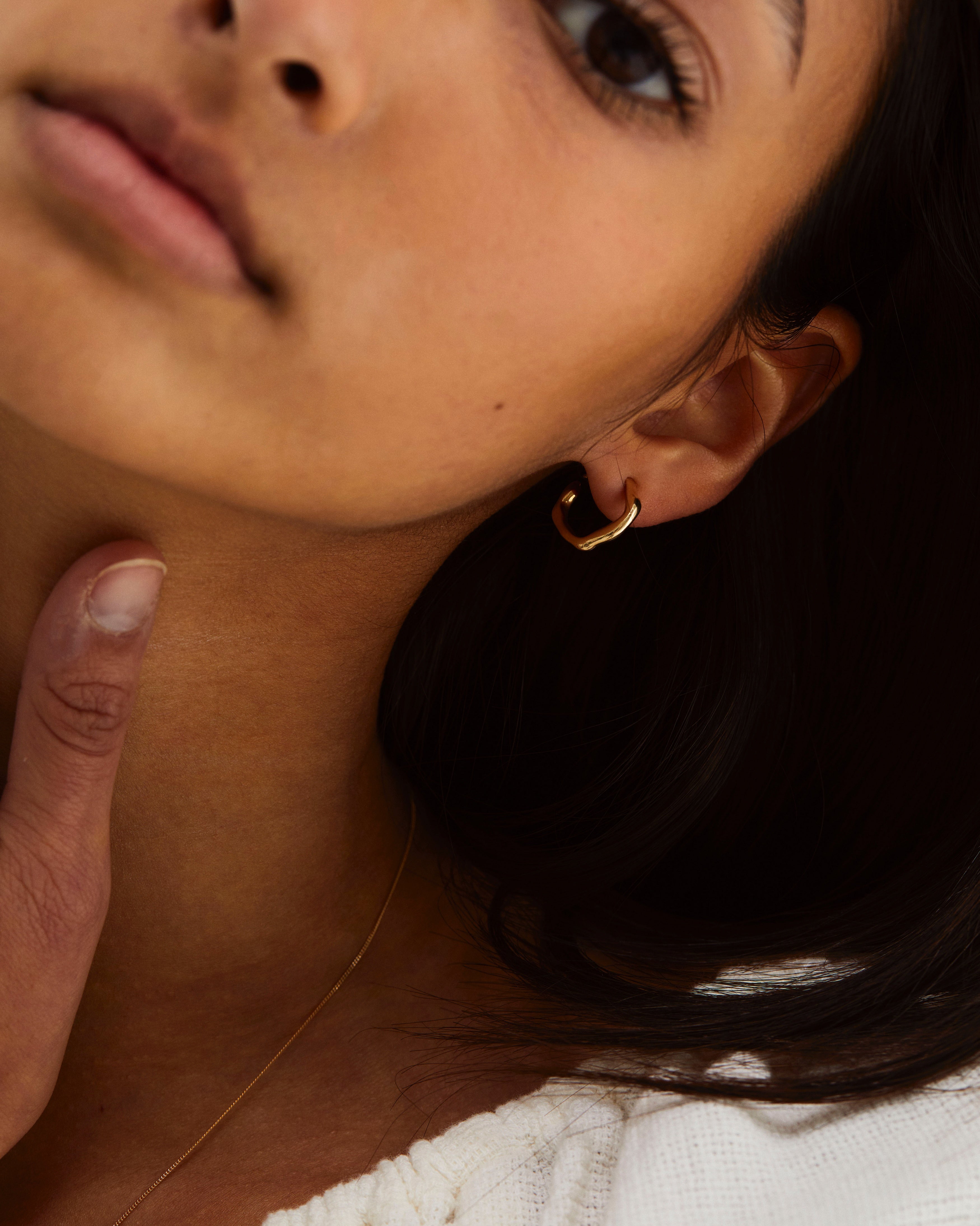 A woman wearing the Organic Hoops in yellow gold.