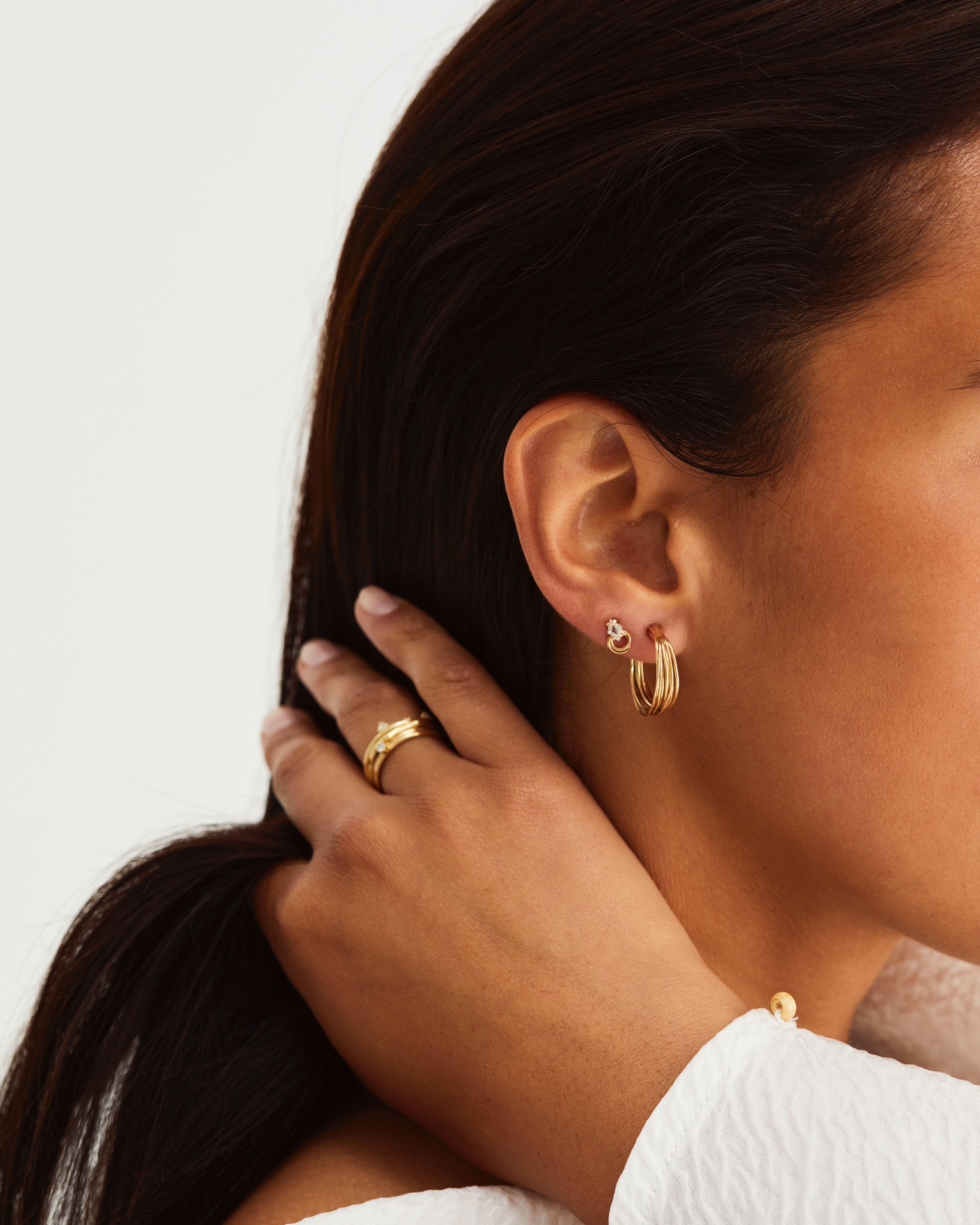 A woman wearing the Kamali Hoops and Nuna Studs | Savannah Sunstone in yellow gold.