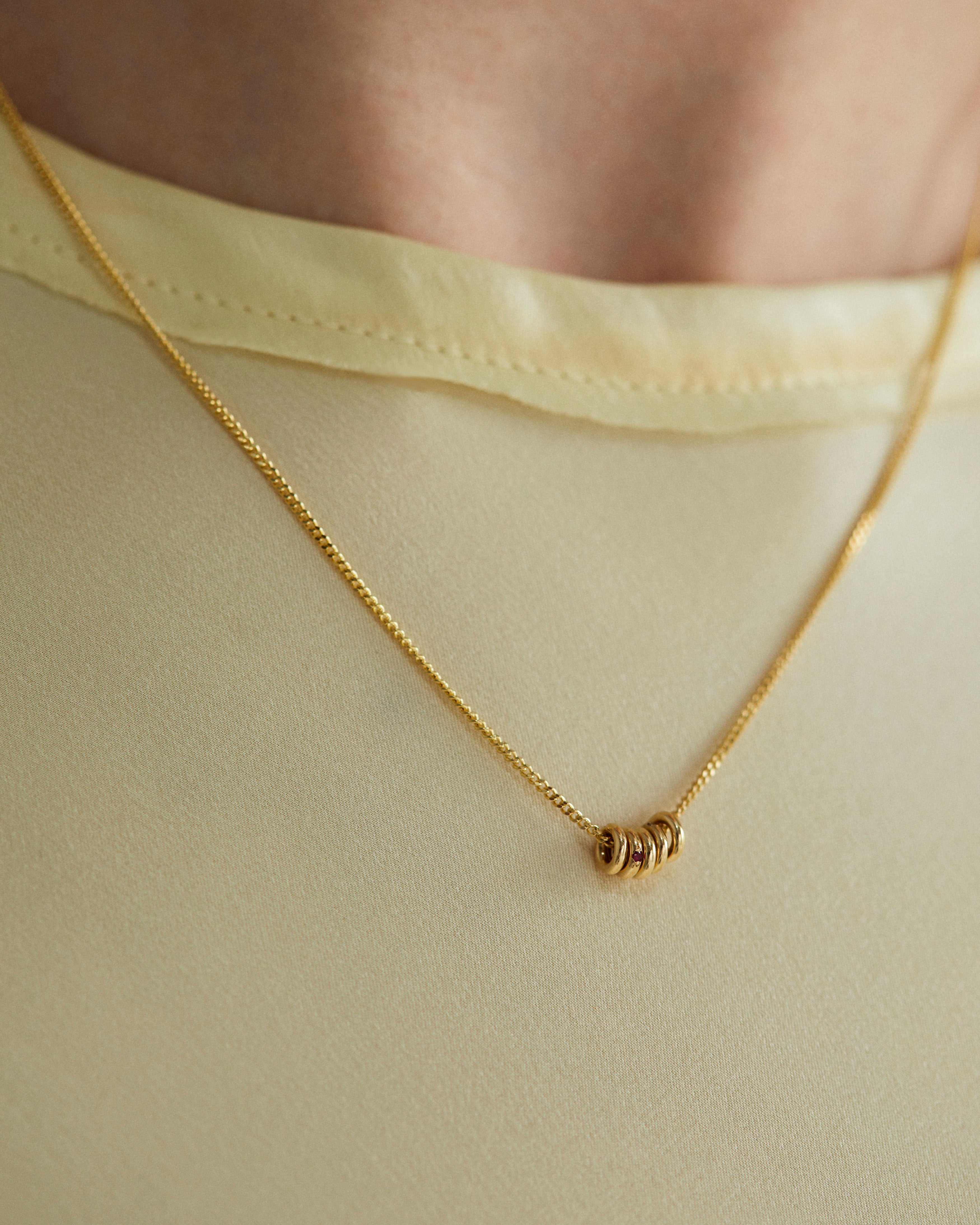 Aether Necklace in Yellow Gold with multiple charms.