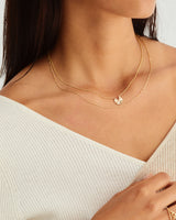 A model wearing the Pan Necklace in yellow gold.