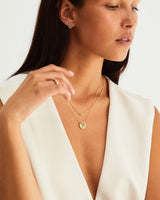 A woman wearing the Mana Necklace in yellow gold.