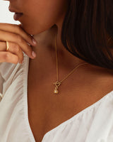 A woman wearing the Terra Necklace | Diamond in yellow gold.