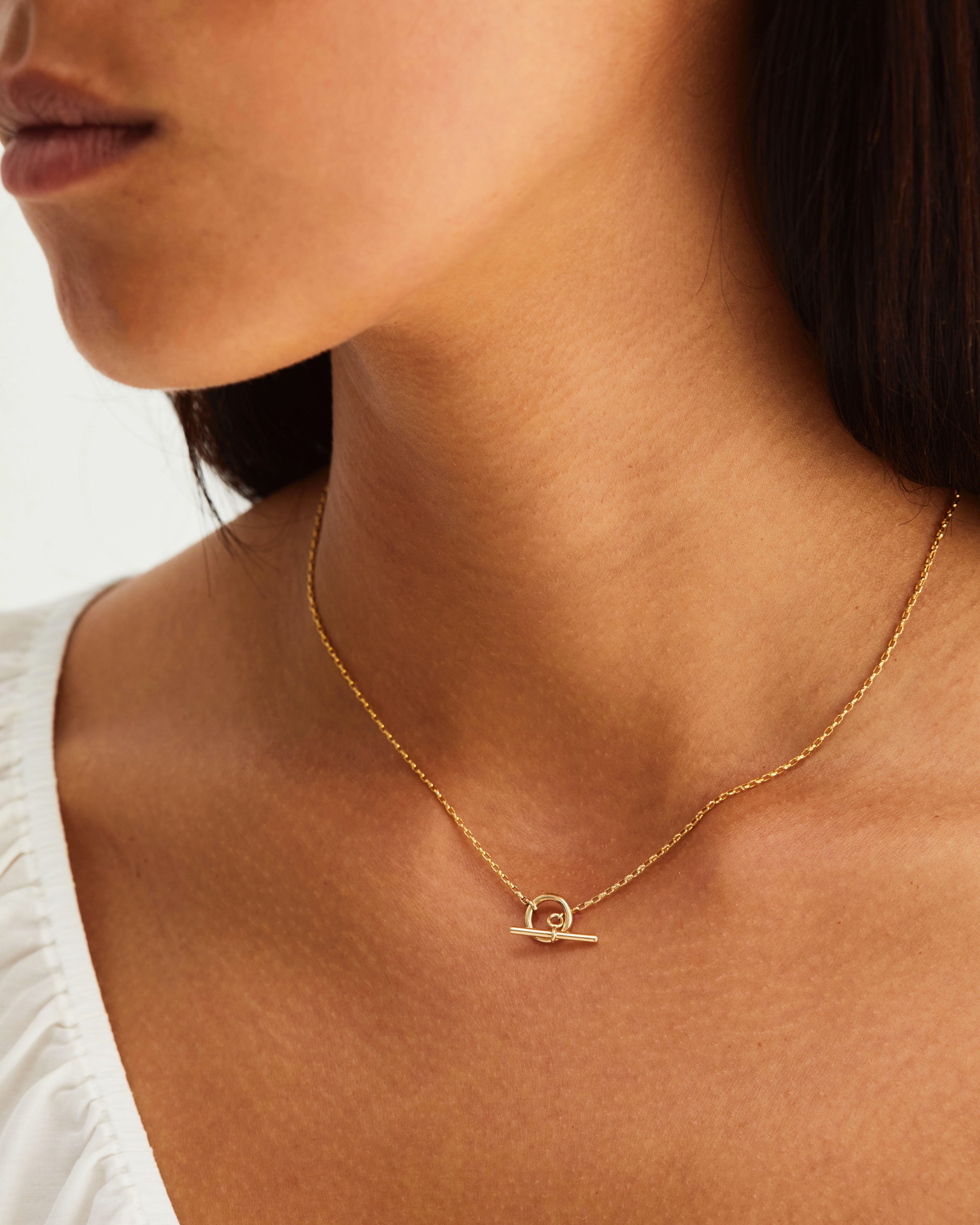 A model wears our fine Terra Chain Necklace in yellow gold