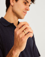 A man wears the Organic Wedding Ring and Organic Stacking Ring in Yellow Gold