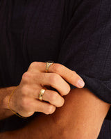 A man wears 6mm seam wedding ring in yellow gold