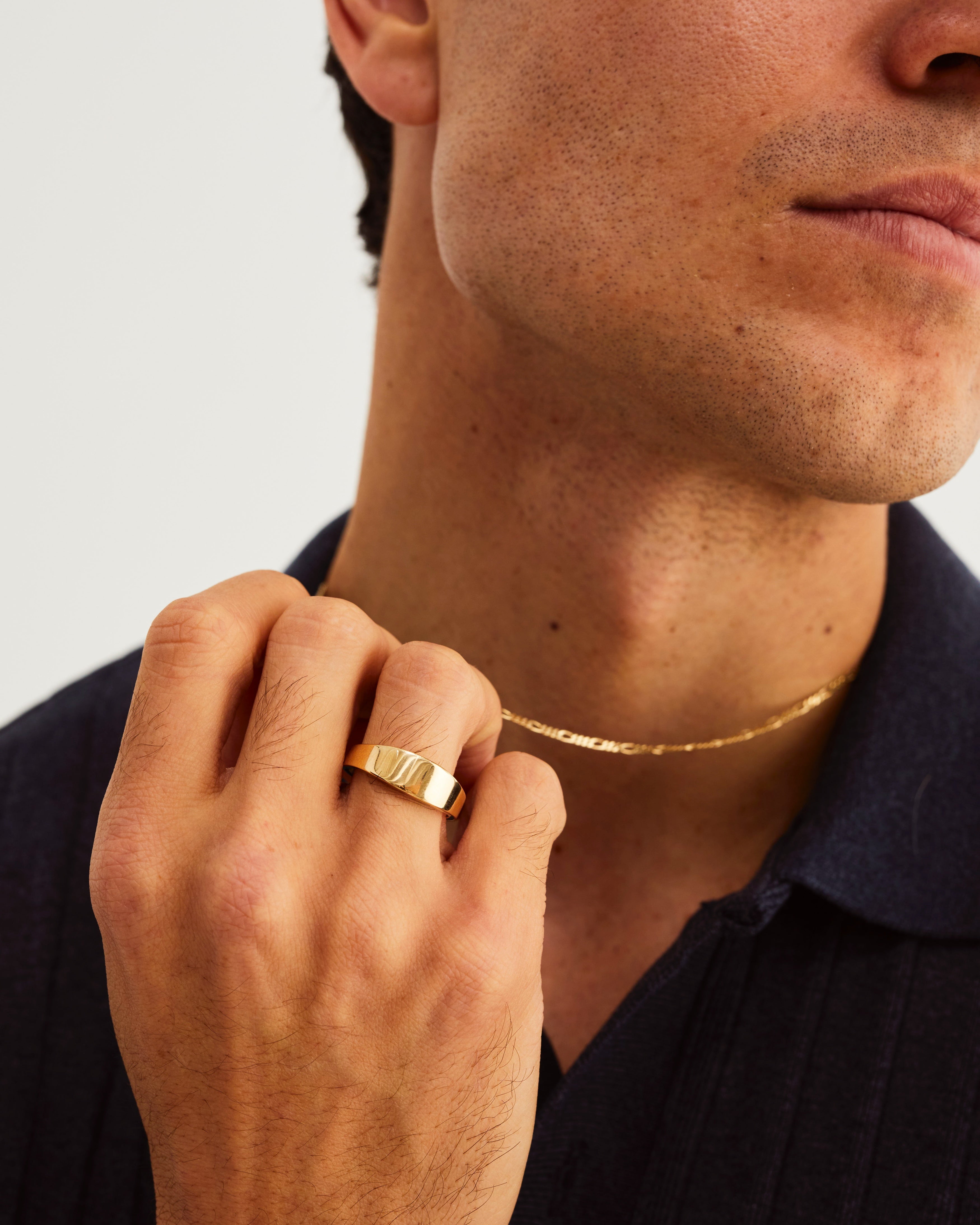 A man wears an Amos Signet Ring in Yellow Gold