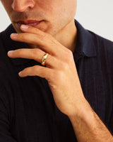 A man wears 5mm classic wedding ring in yellow gold