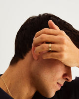 A man wears 5mm flat wedding ring in yellow gold