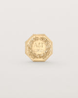 yellow gold six pence coin engraved with a crest and initials