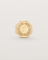 yellow gold six pence coin engraved with a crest and initials