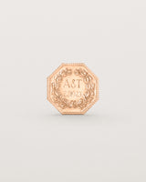 Rose gold six pence coin engraved with a crest and initials