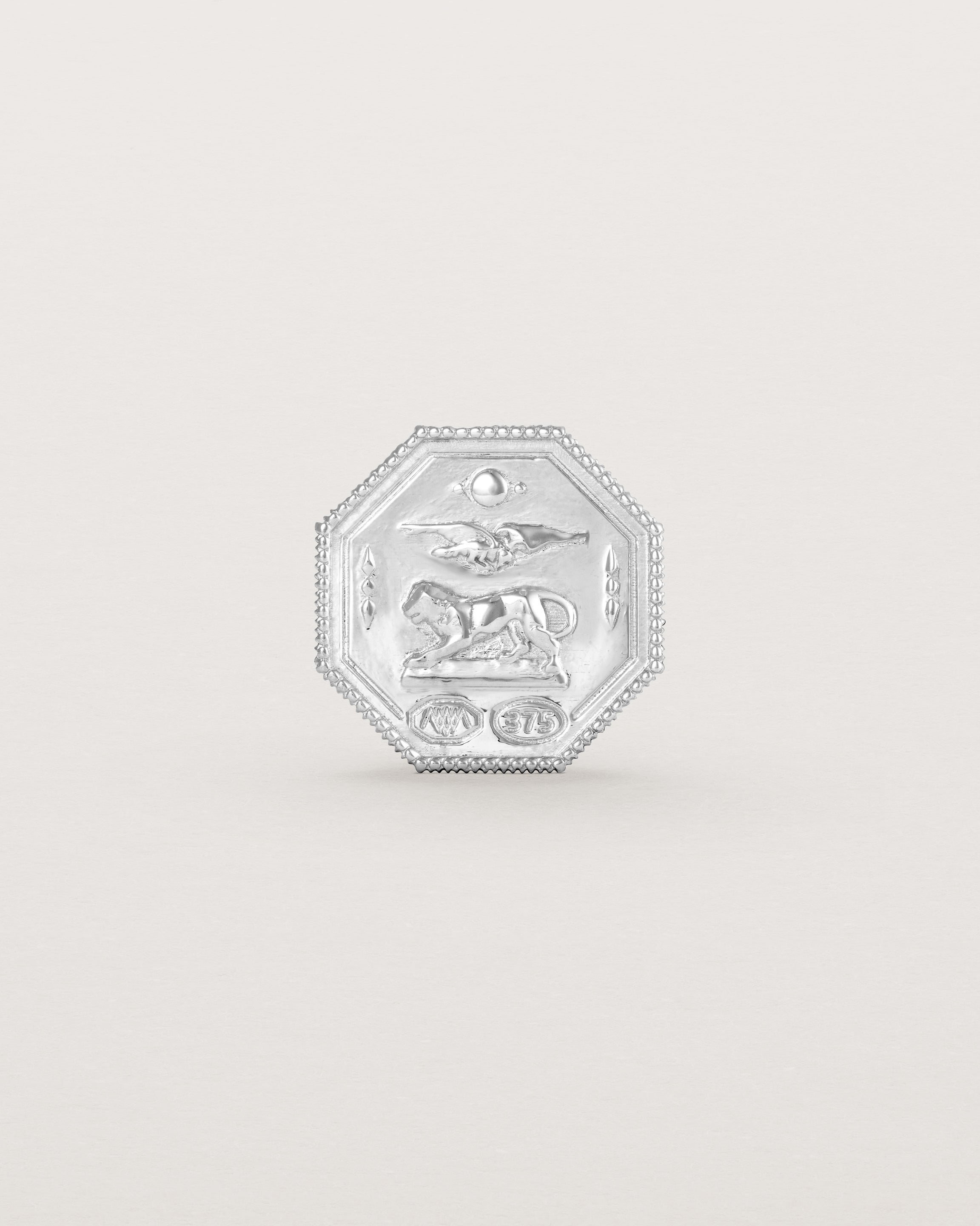 Sterling silver six pence coin engraved with a crest and initials