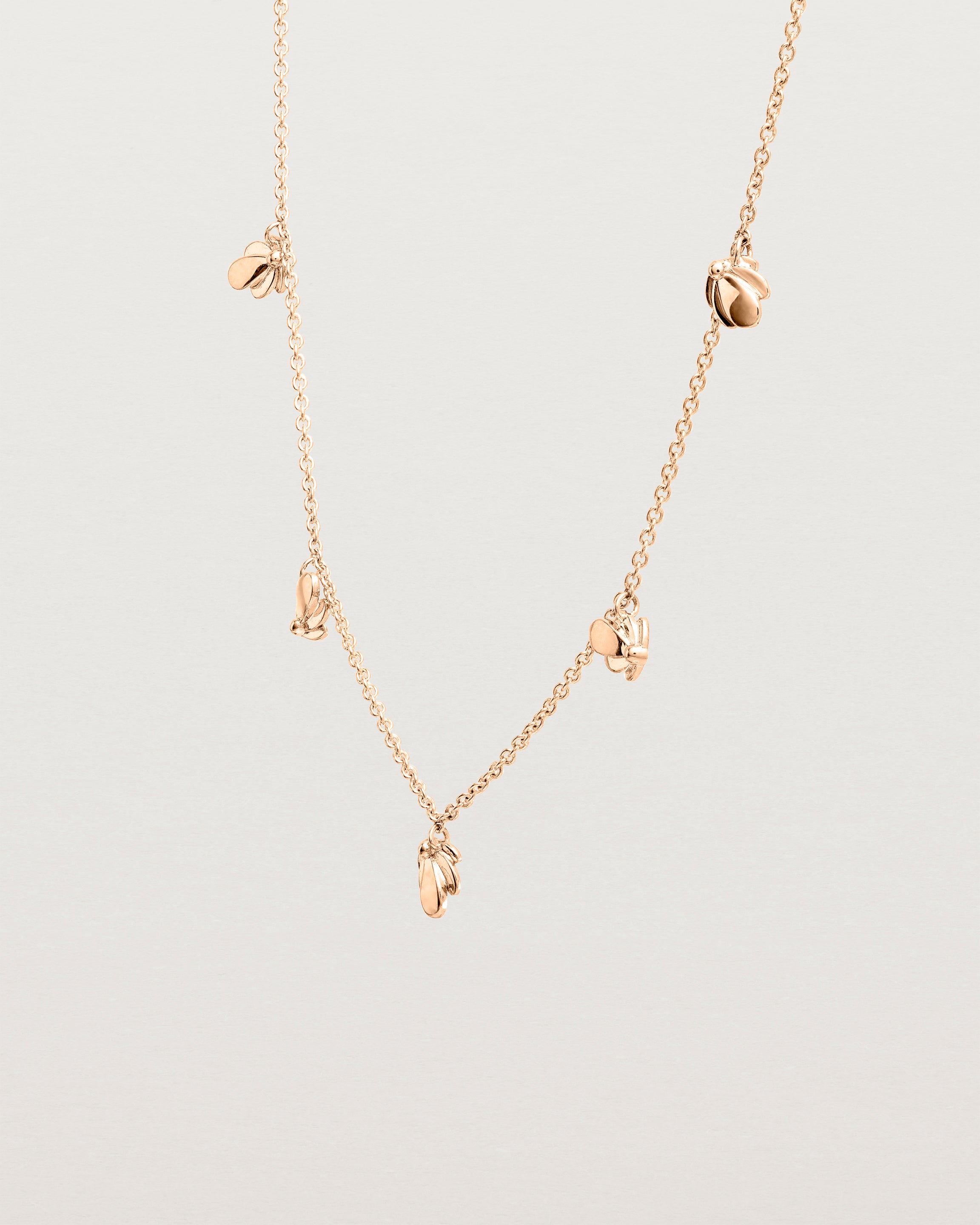 Angled view of the Aeris Charm Necklace in Rose Gold.