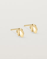 Angled view of the Aeris Studs in yellow gold.