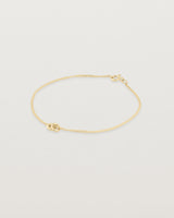 Aether bracelet featuring two round charms in yellow gold