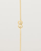 close up view of Aether bracelet featuring two round charms in yellow gold