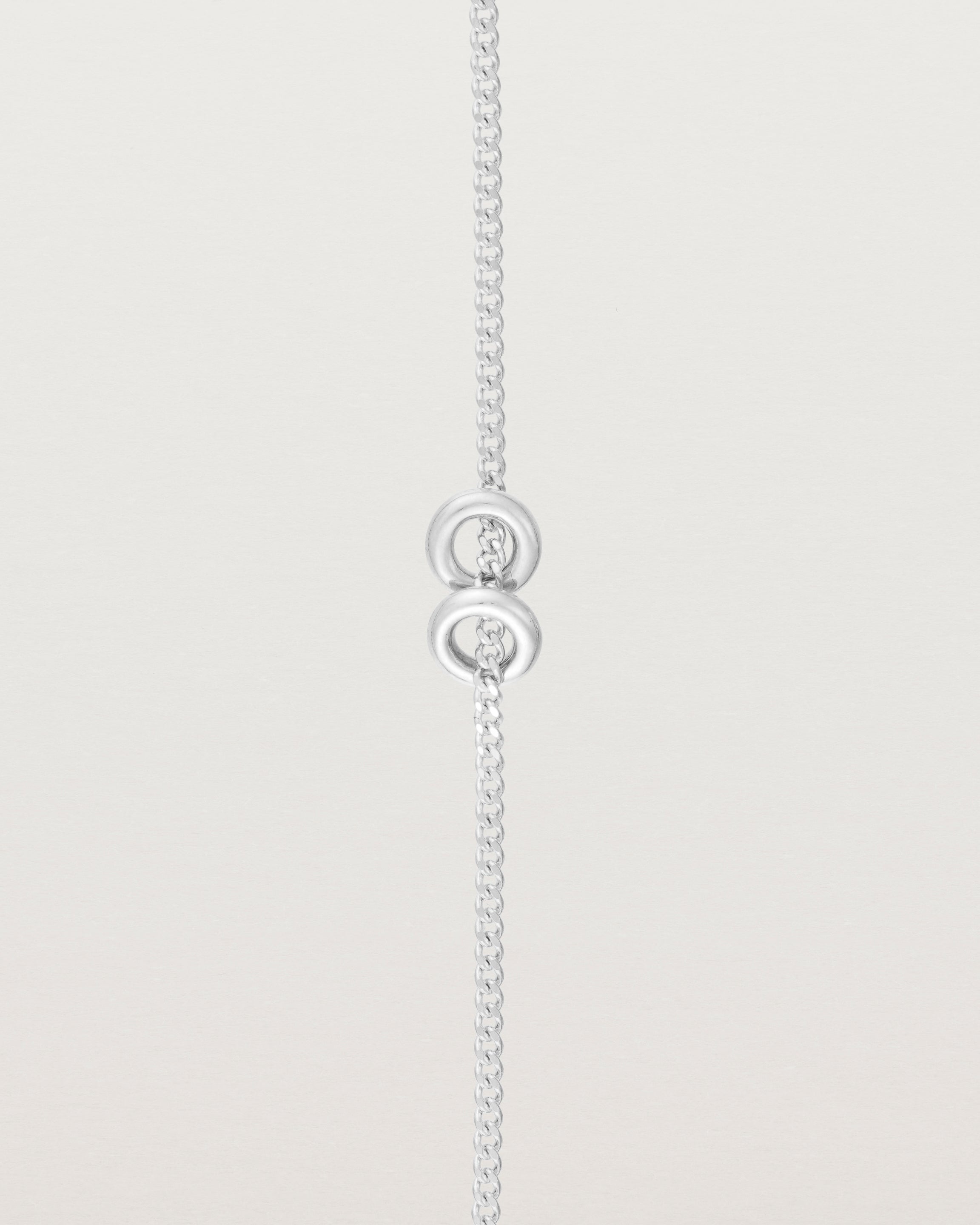 close up view of the Aether Bracelet showing two round charm in sterling silver