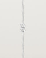 close up view of the Aether Bracelet showing two round charm in sterling silver
