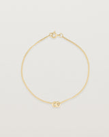 top down view of Aether bracelet featuring two round charms in yellow gold
