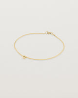 Side view of Aether bracelet featuring one round charm in yellow gold