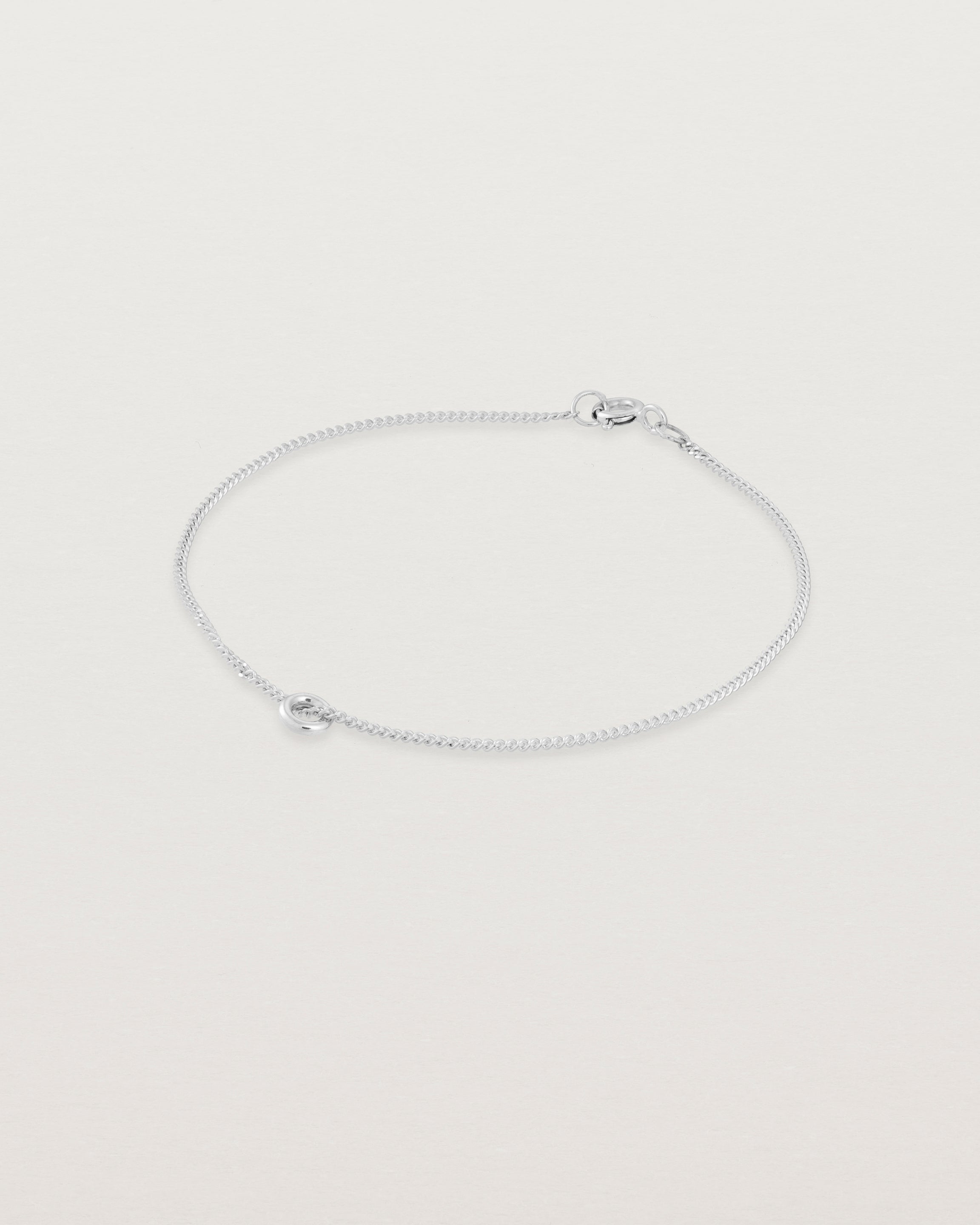 Side view of the Aether Bracelet showing one round charm in sterling silver
