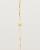 View of Aether Bracelet featuring one round charm in yellow gold.