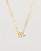 close up of Aether necklace showing two round charms in yellow gold