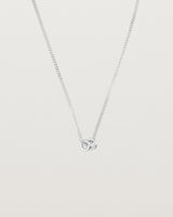 Pulled back image of the. Aether necklace in white gold with two round charms