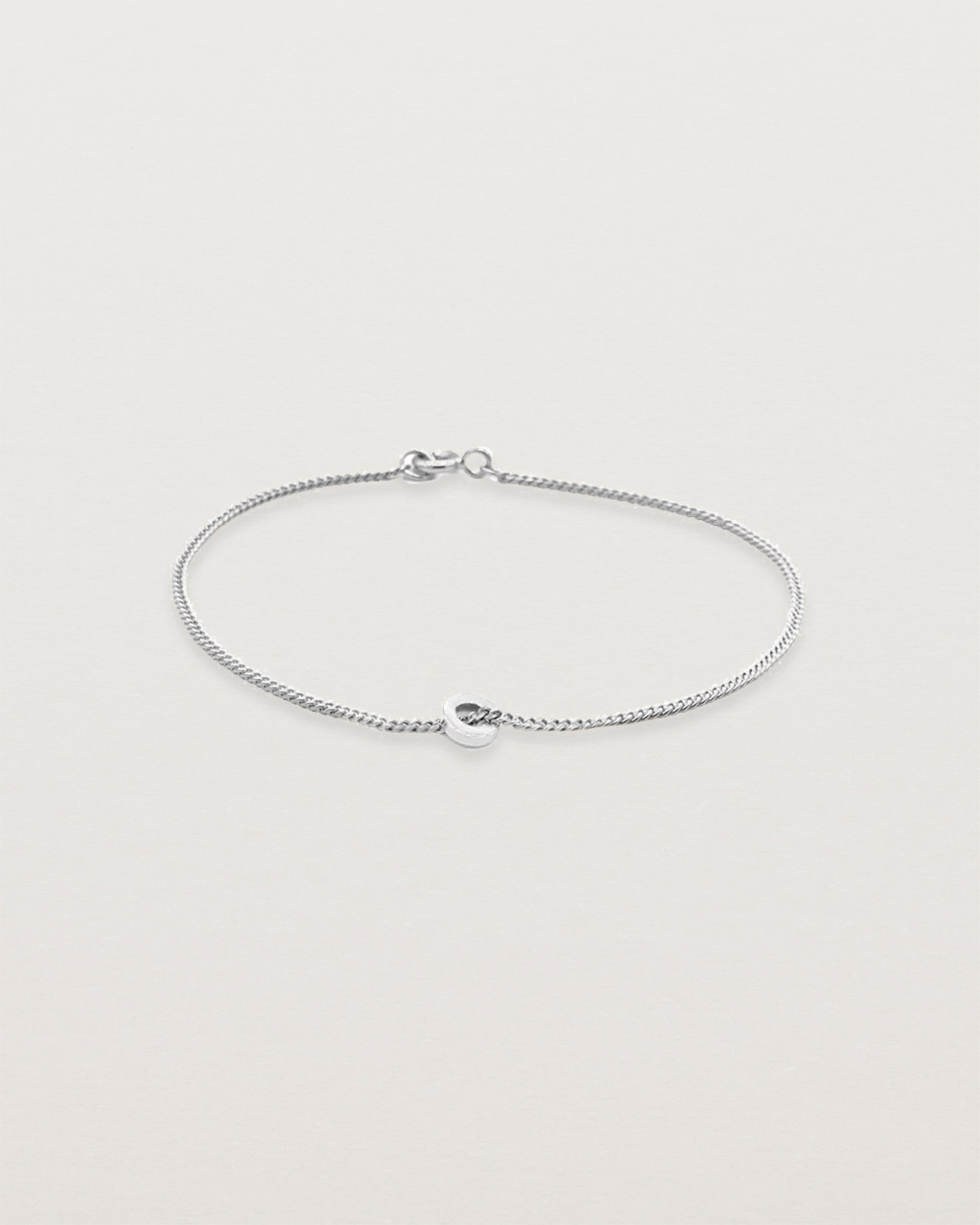 A fine sterling silver chain bracelet featuring a sterling silver circular charm