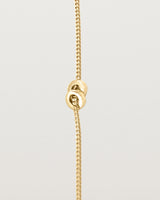 A fine yellow gold chain bracelet featuring a square circular charm