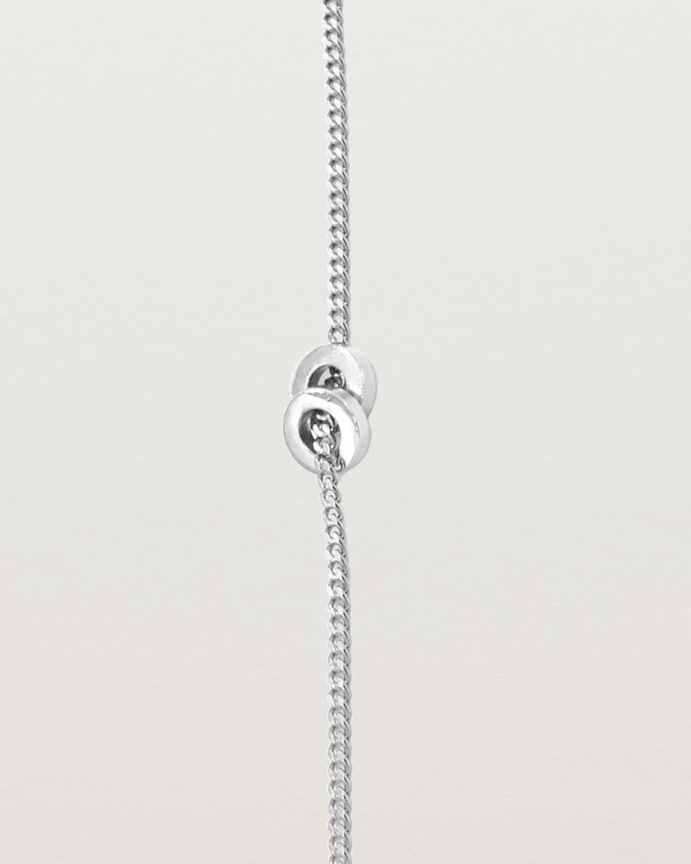 A fine sterling silver chain bracelet featuring a sterling silver circular charm