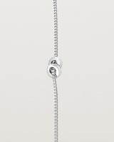 A fine sterling silver chain bracelet featuring a sterling silver circular charm