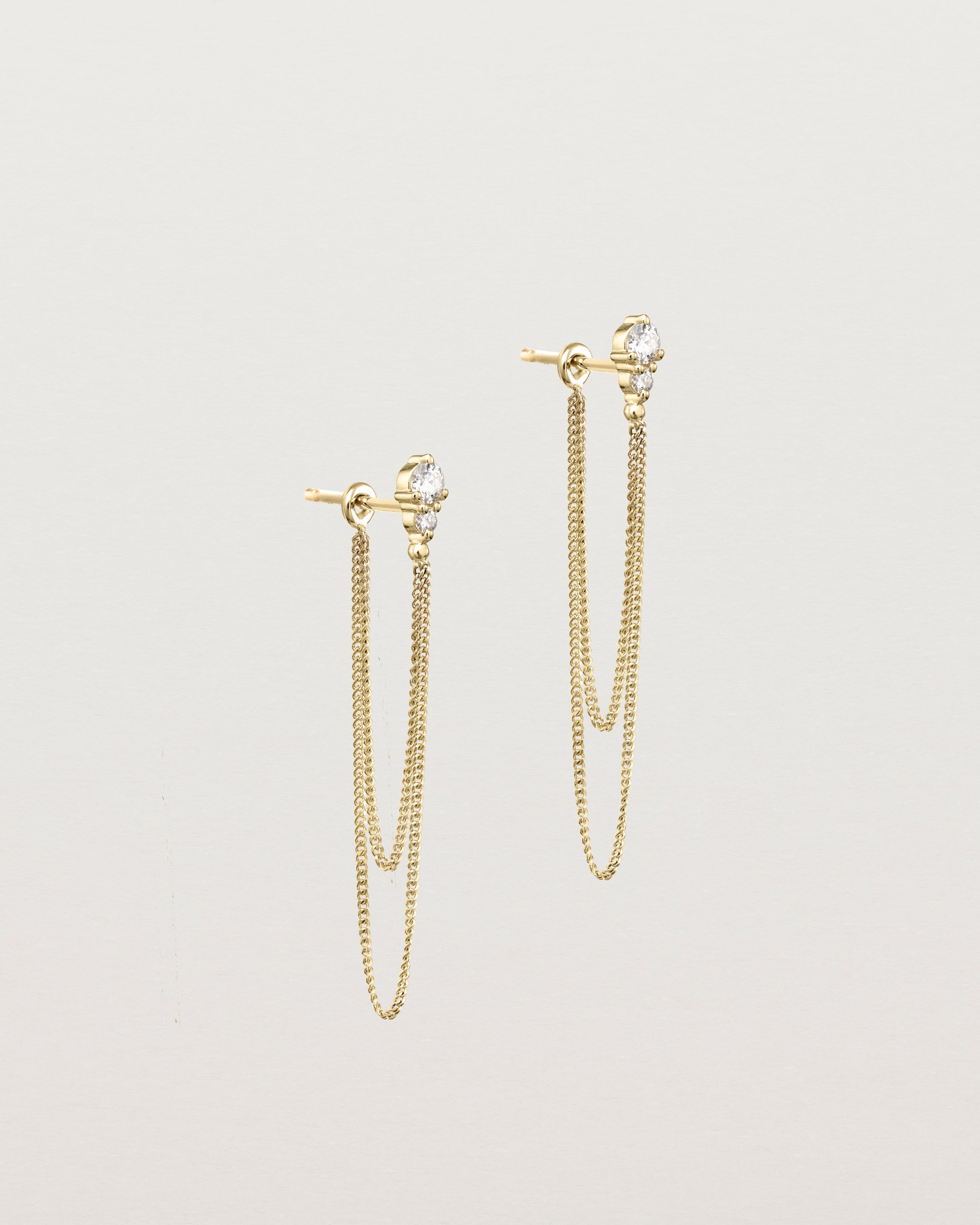 Side view of the Aiona Loop Studs | Diamonds in yellow gold.