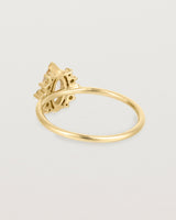 A yellow gold ring featuring a marquise champagne quartz with a halo of white diamonds