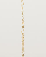A close up of the Anam Charm Bracelet in yellow gold.