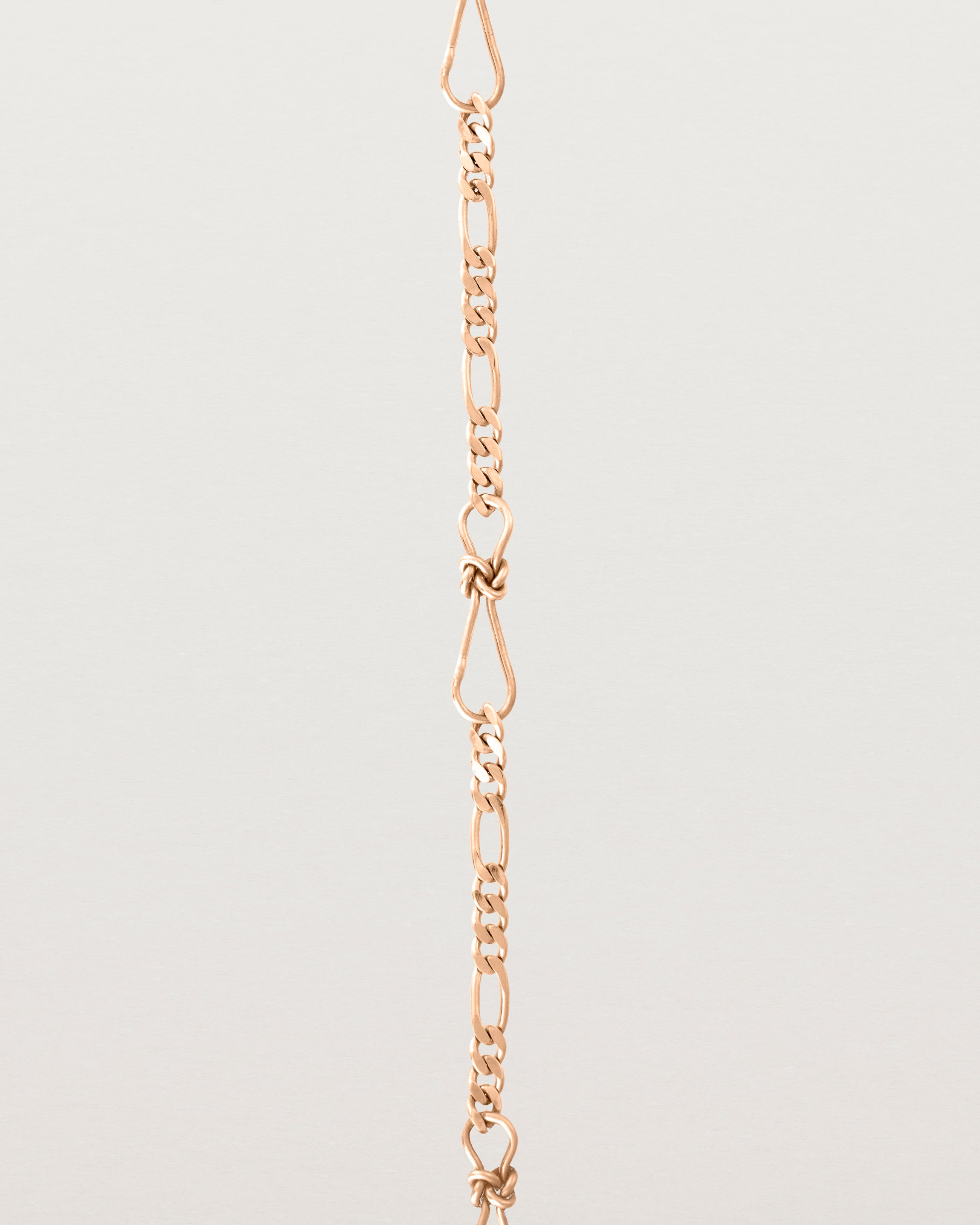 A close up of the Anam Charm Bracelet in rose gold.