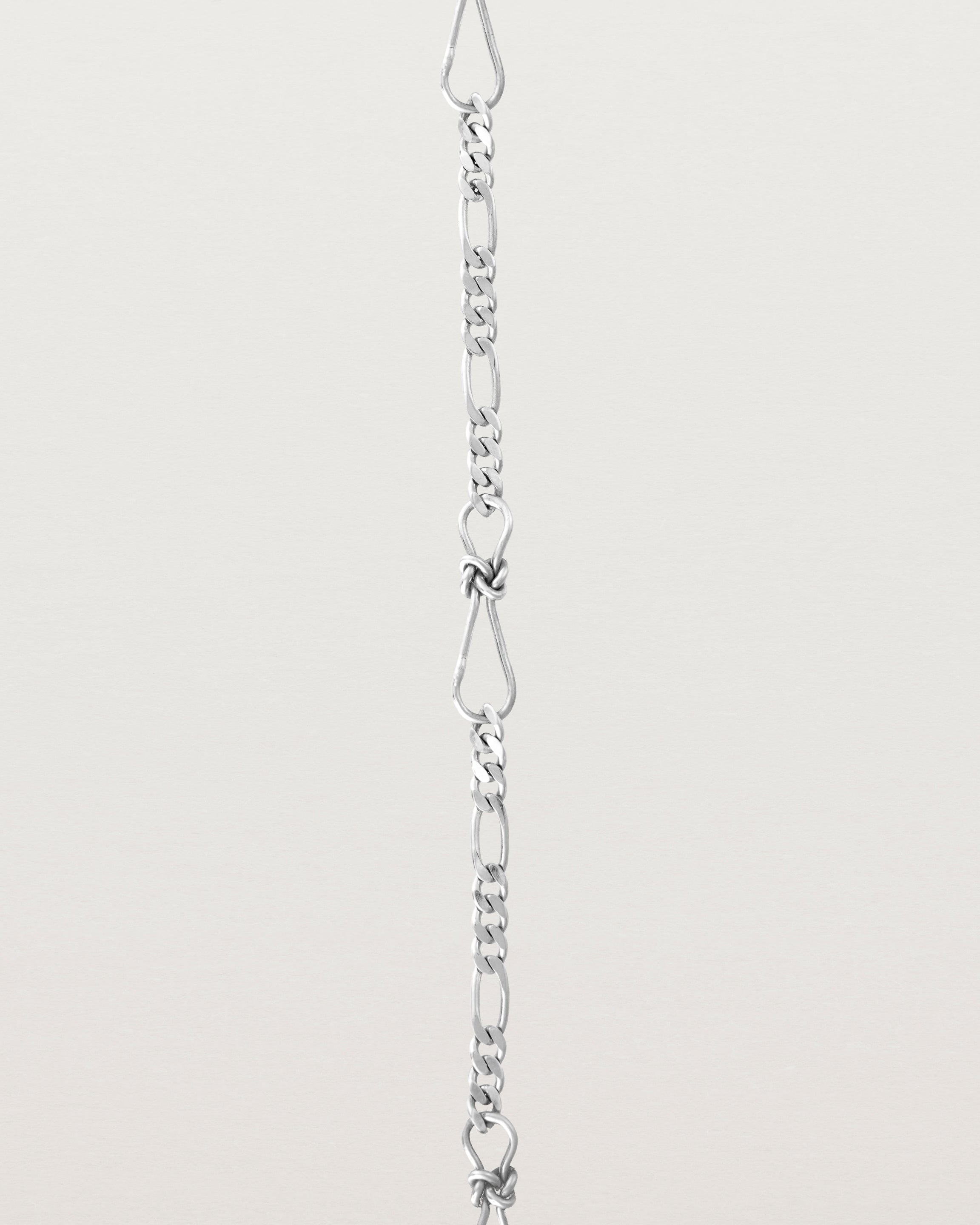 A close up of the Anam Charm Bracelet in sterling silver.