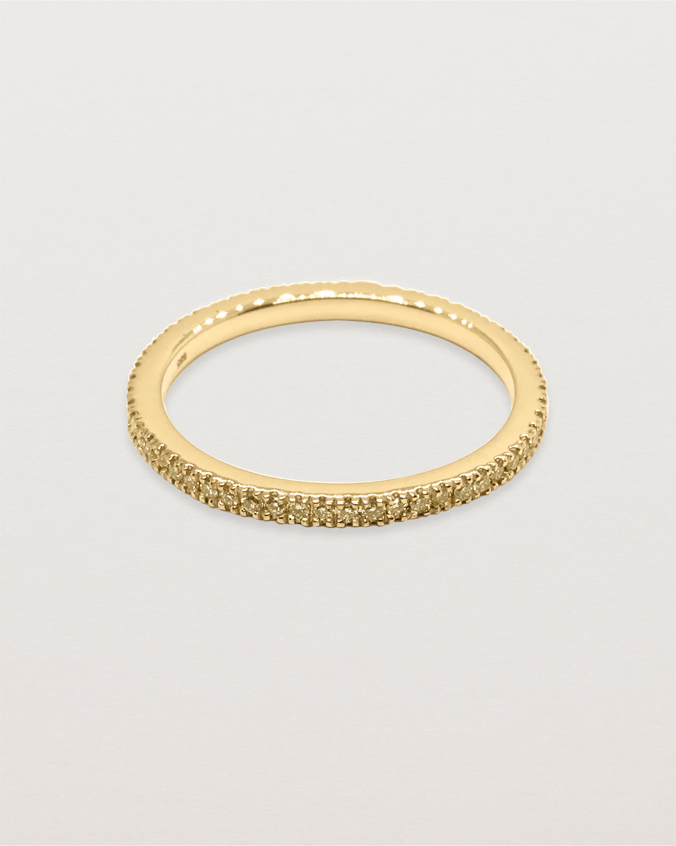 yellow gold band featuring micro pave champagne diamonds