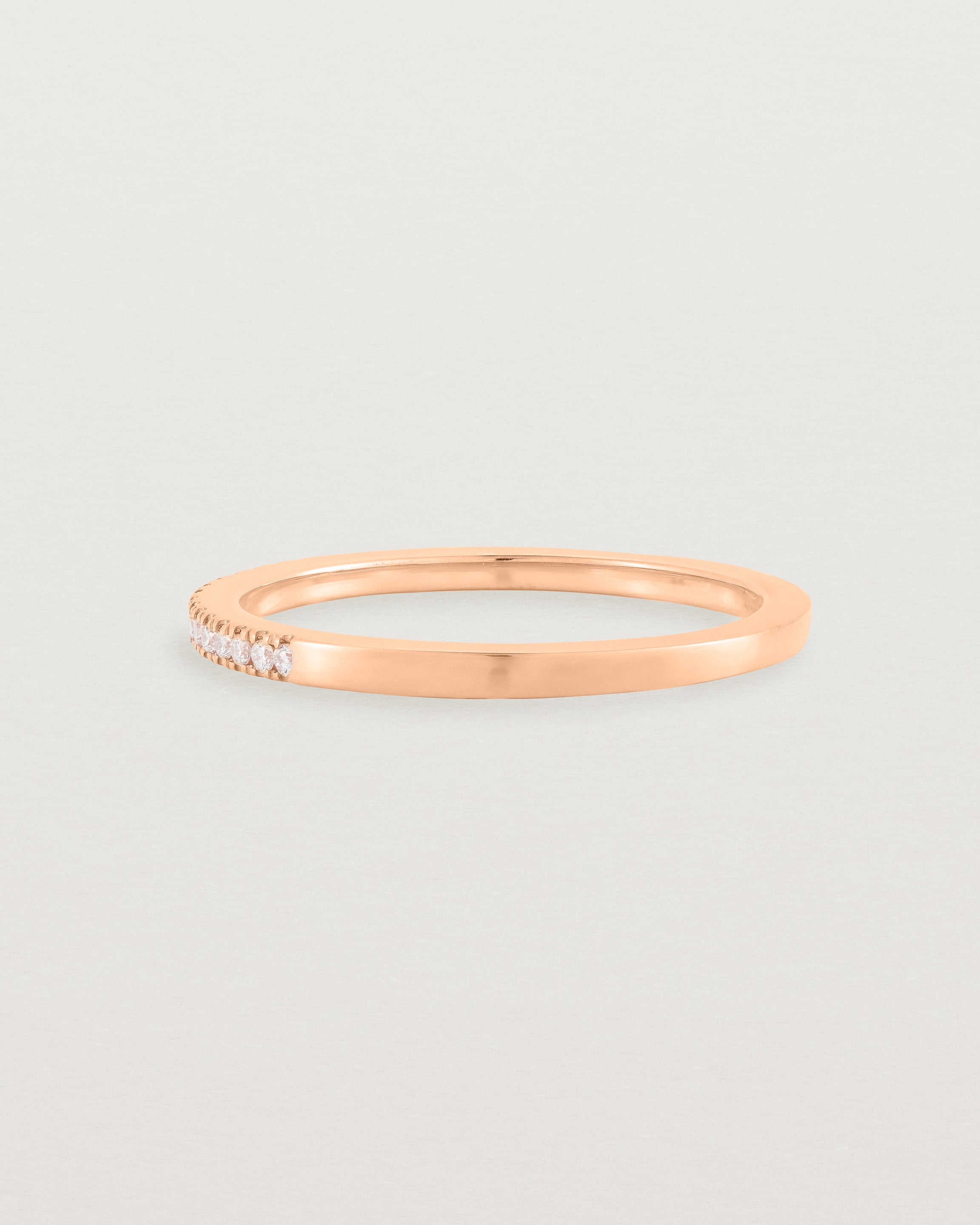 rose gold band with half a band of micro pave diamonds