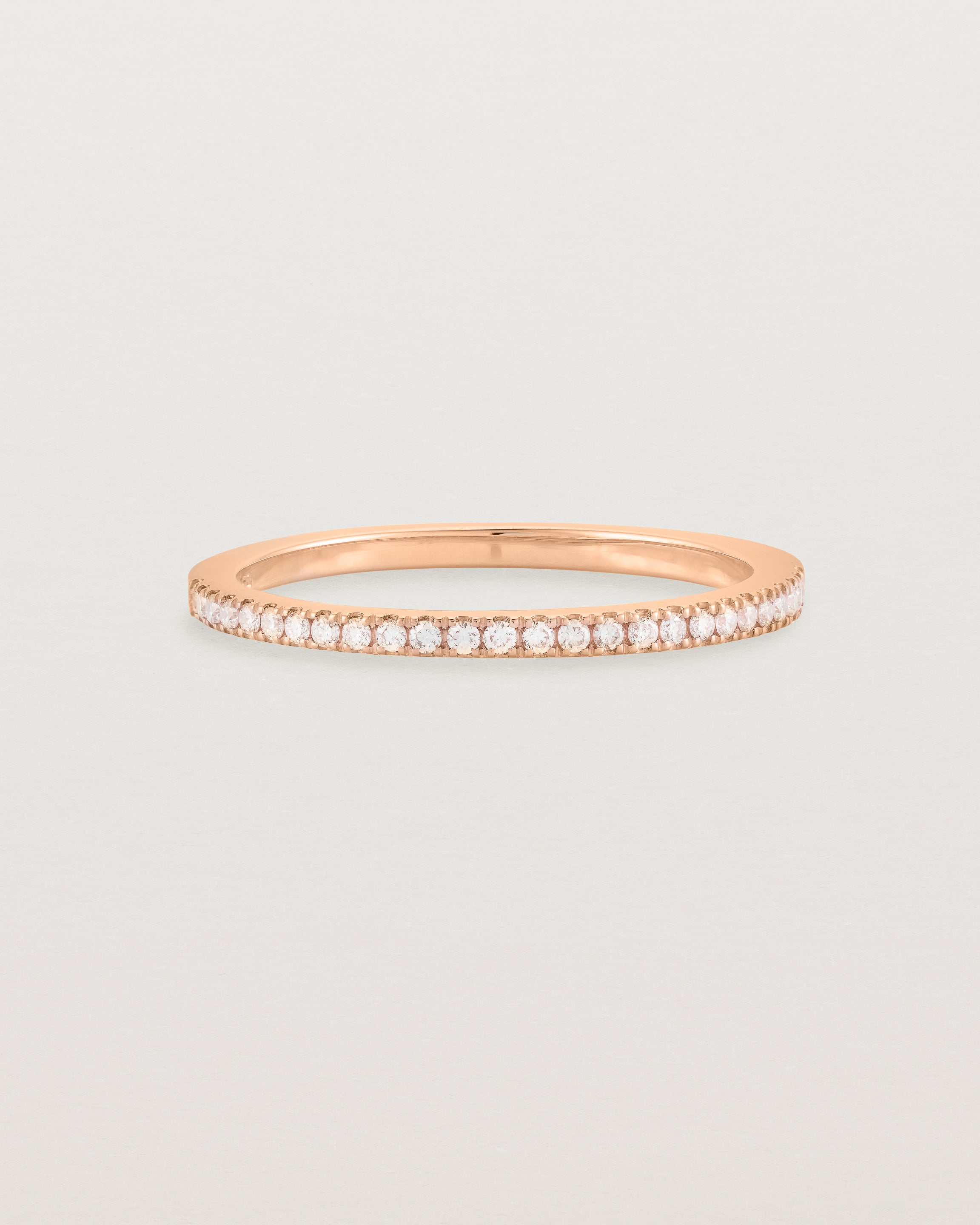 rose gold band with half a band of micro pave diamonds