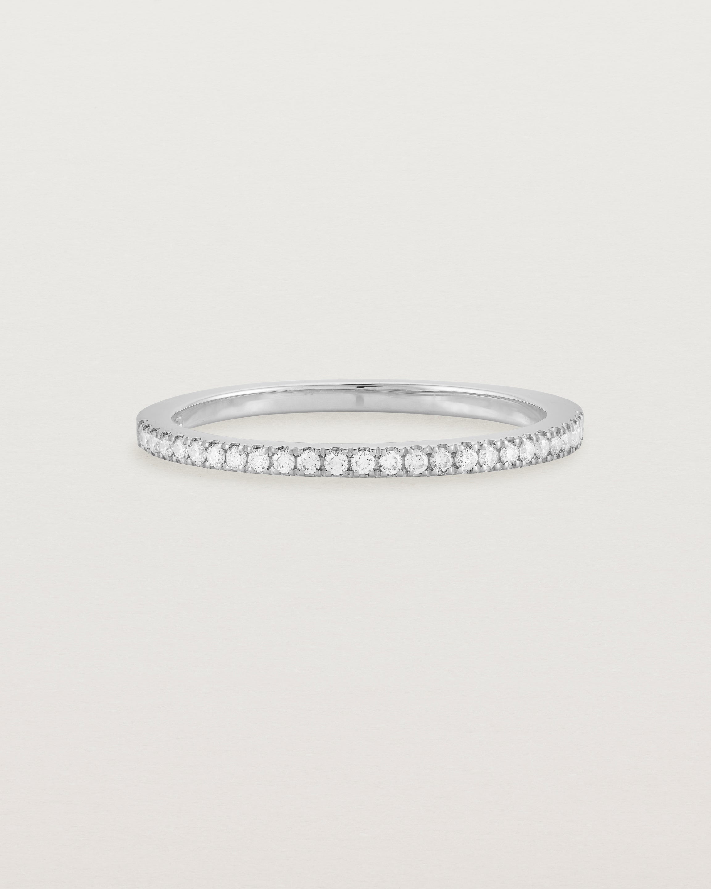 white gold band with half a band of micro pave diamonds