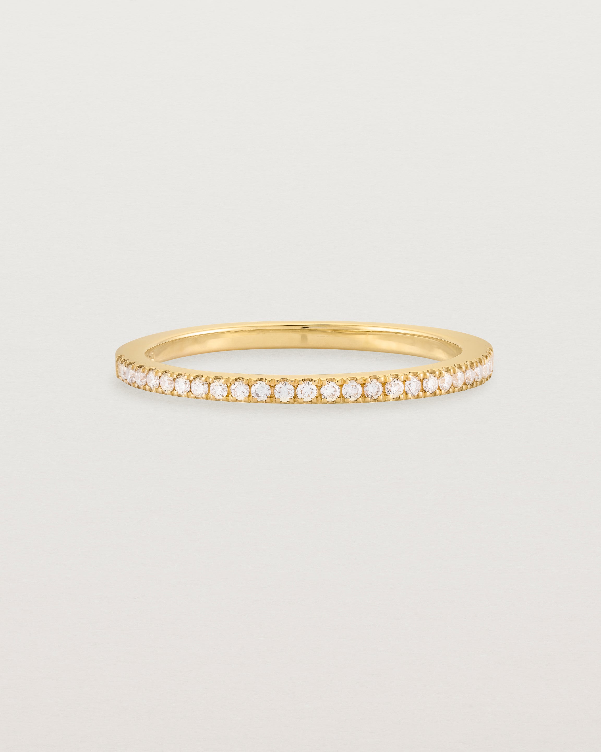 yellow gold band with half a band of micro pave diamonds