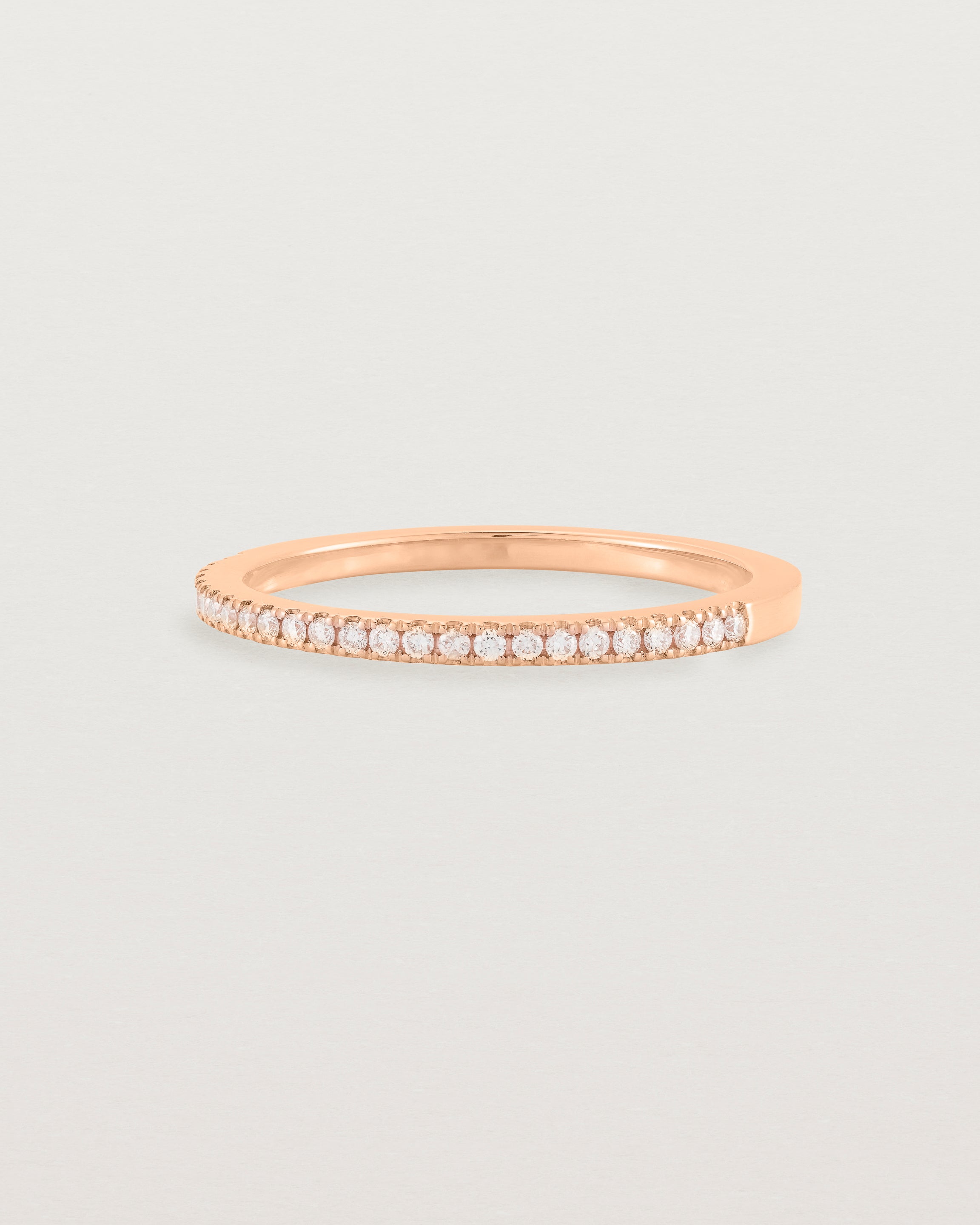 rose gold band with half a band of micro pave diamonds