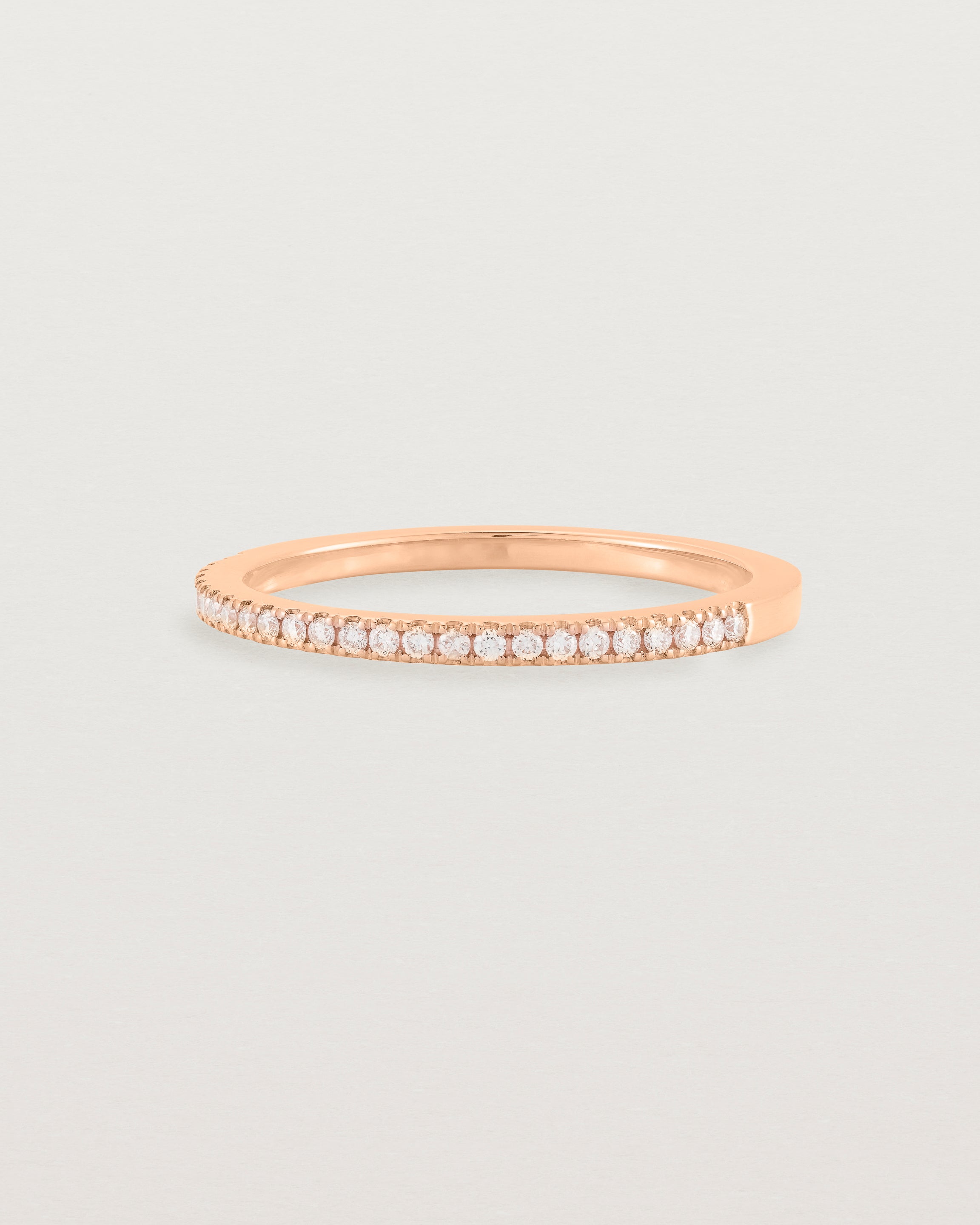 rose gold band with half a band of micro pave diamonds