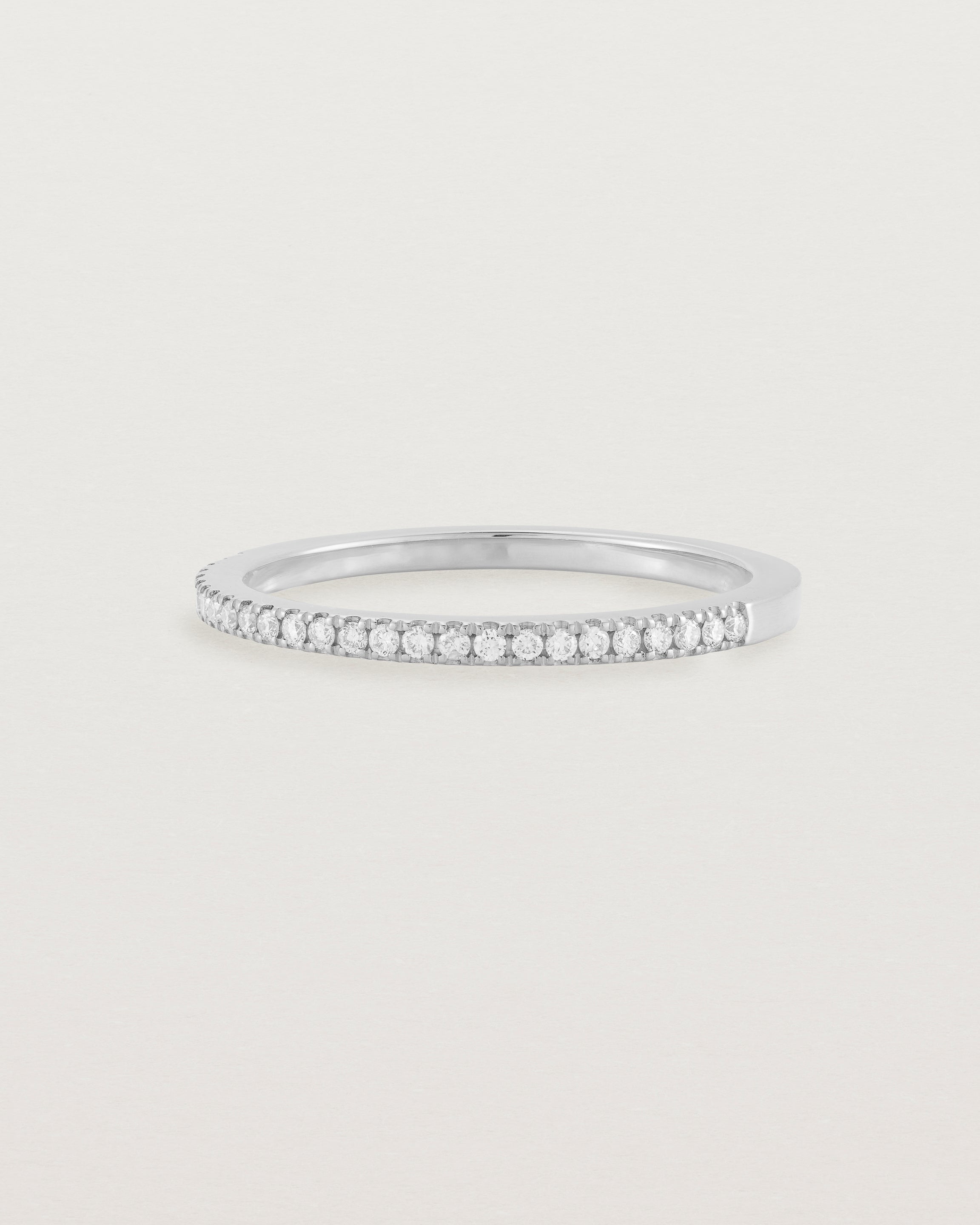 white gold band with half a band of micro pave diamonds