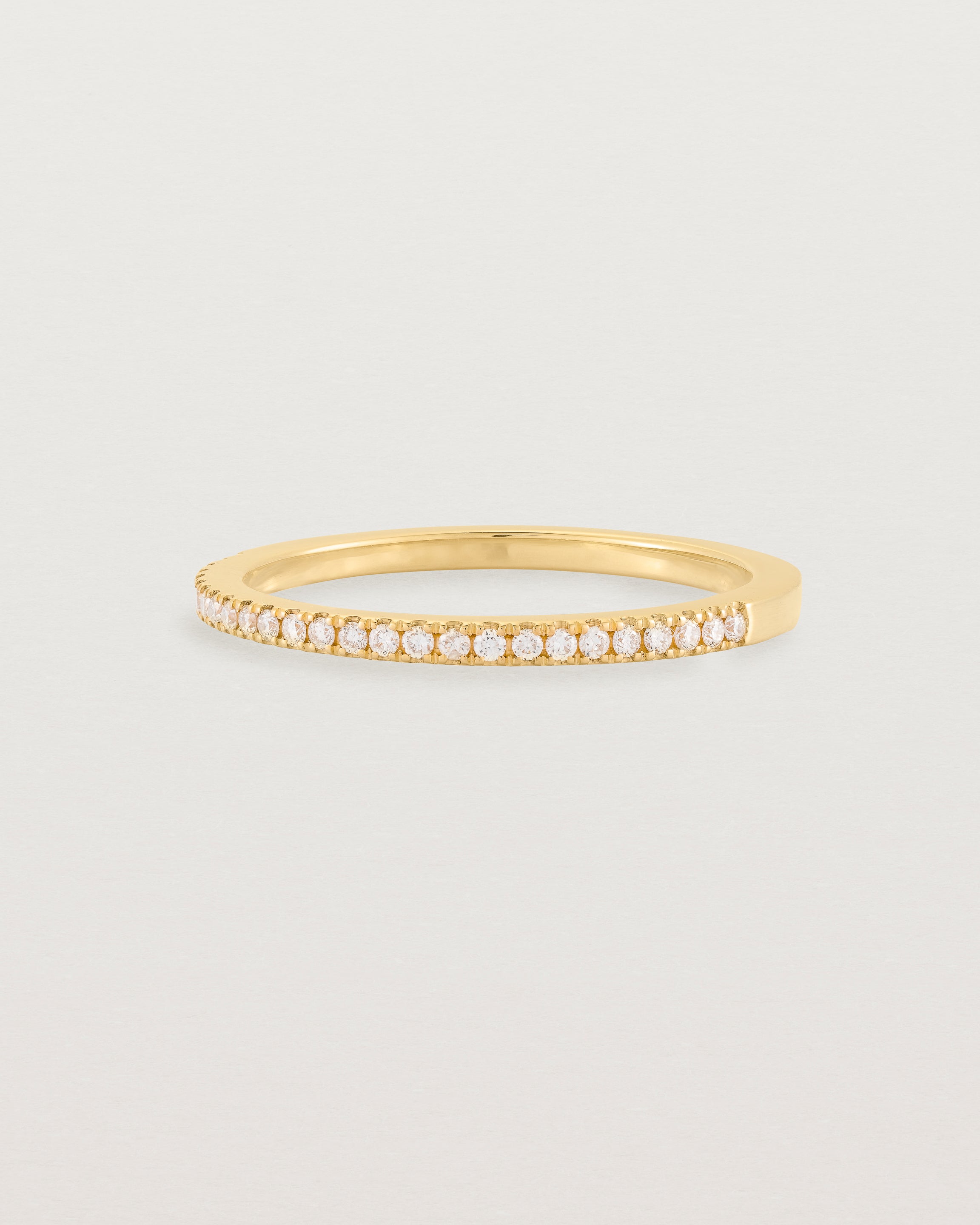 yellow gold band with half a band of micro pave diamonds